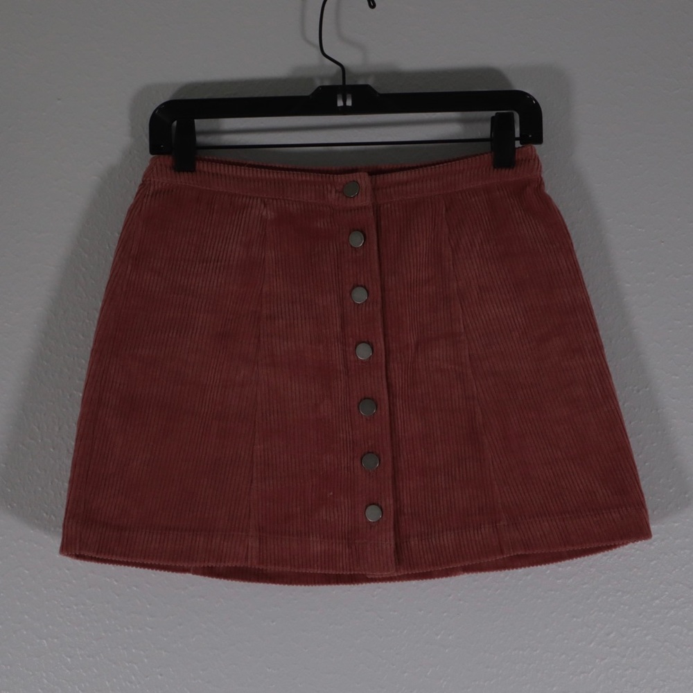 Pink corduroy mini skirt with front button detail